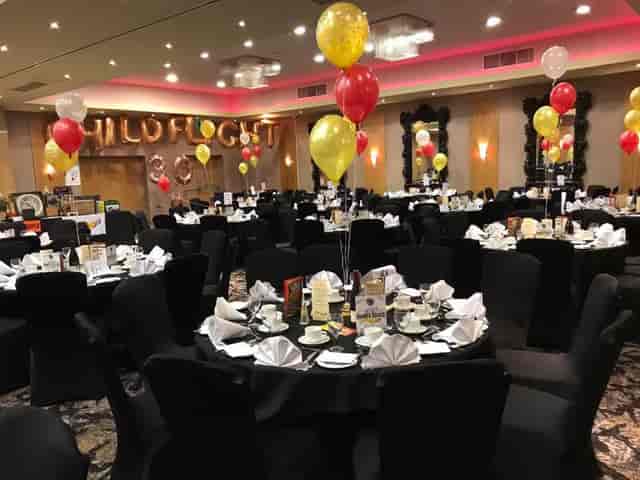 Elegant Sauvignon suite with black tablecloths for corporate gala events.