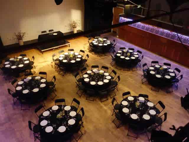 Banquet-style gala setup at The Tabernacle with black linens and stage for corporate dinner events.