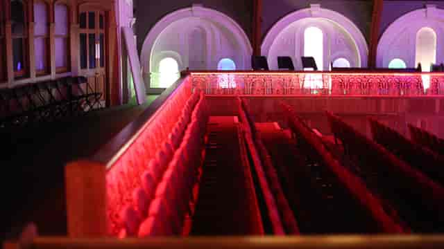 Tiered theater with LED accent lighting for live performances and corporate event hosting.