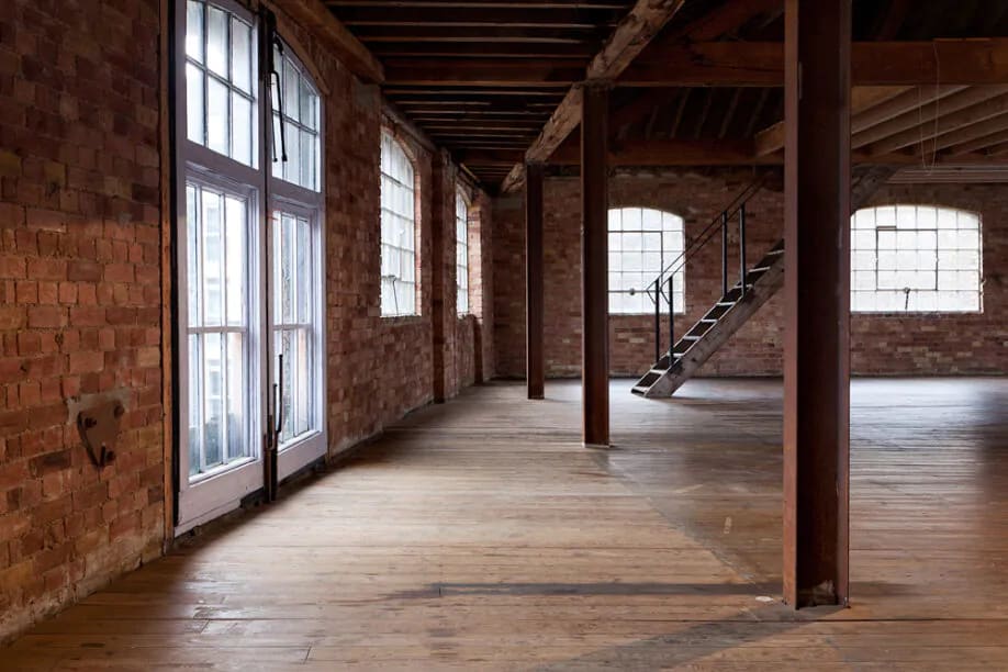Versatile event space at 47/49 Tanner Street with exposed brick walls for creative gatherings.