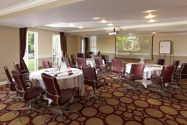 Marlborough meeting room with round tables, ideal for workshops and presentations.