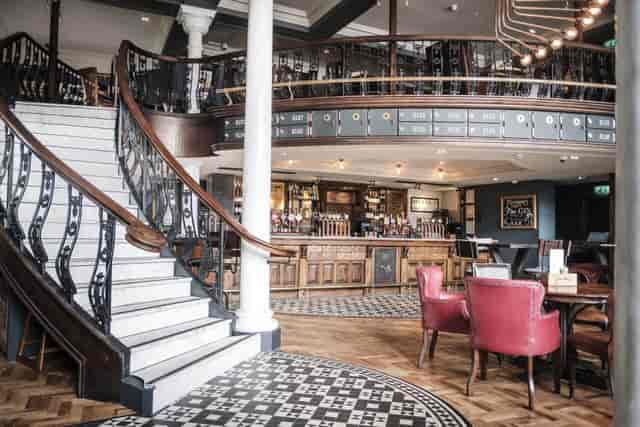 Gallery Bar mezzanine with focal bar for corporate mixers and networking events.