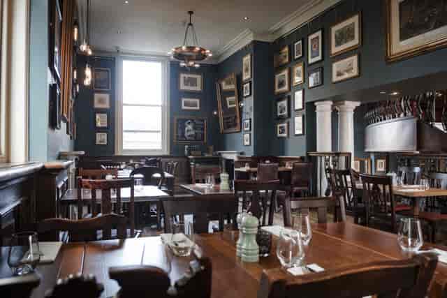 Gallery Bar private dining room with dark walls for corporate lunches and networking events.