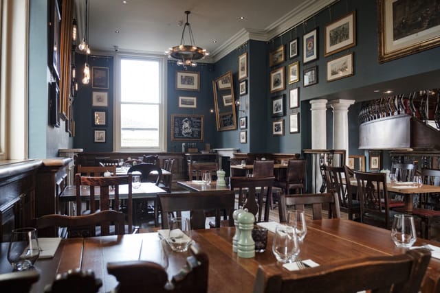 Gallery Bar private dining room with dark walls for corporate lunches and networking events.