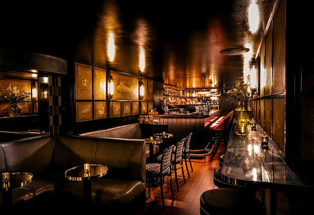 Upscale Upstairs Bar lounge with plush seating for VIP receptions and cocktail hours.
