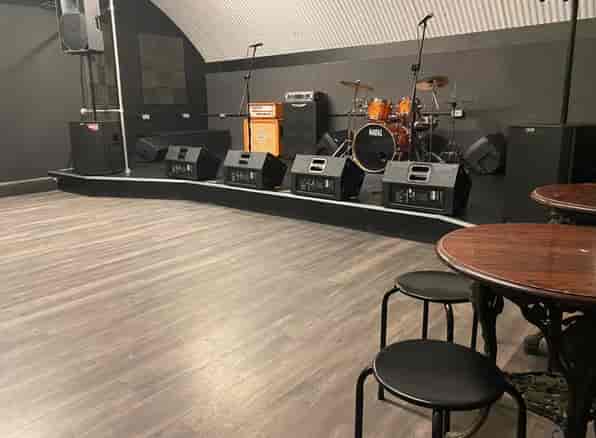 Live music performance stage with sound equipment in versatile event space.