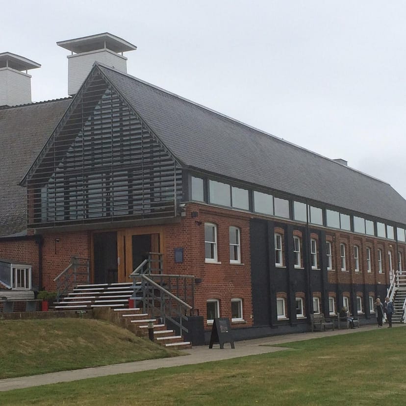 Rustic-chic event venue with brick walls and glass windows for corporate retreats.