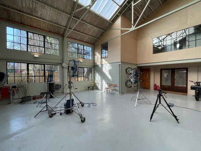 Spacious event venue with high ceilings, ideal for hybrid gatherings and corporate functions.