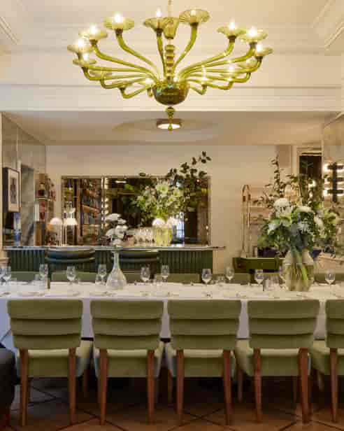 Mural Room at Langan's Brasserie, elegantly set for corporate events with lush greenery.