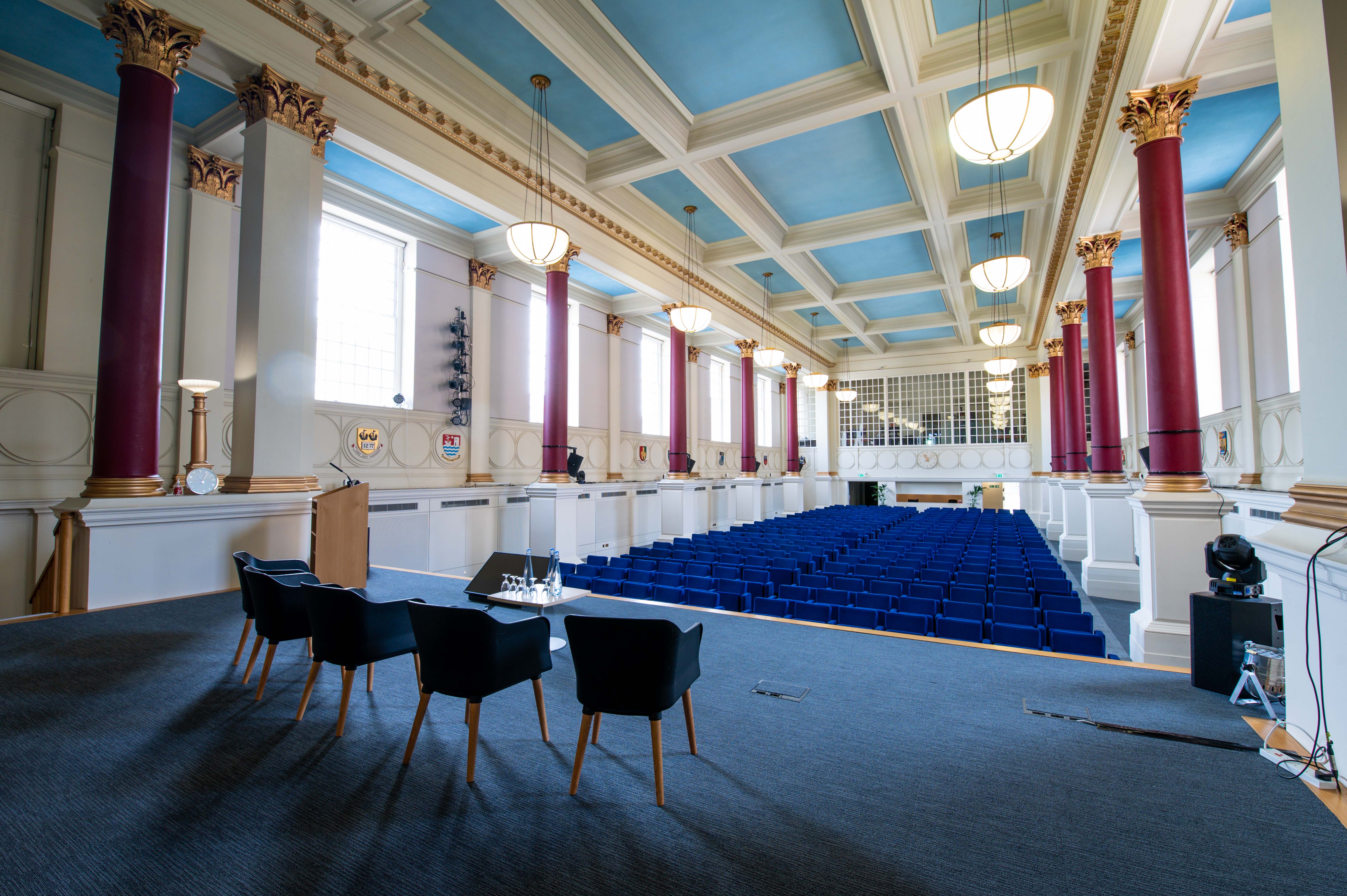 Low-Impact DDR auditorium with blue seating for conferences and lectures.