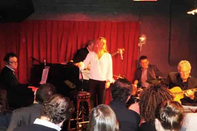 Intimate jazz performance at Bull's Head with vibrant red backdrop for events.