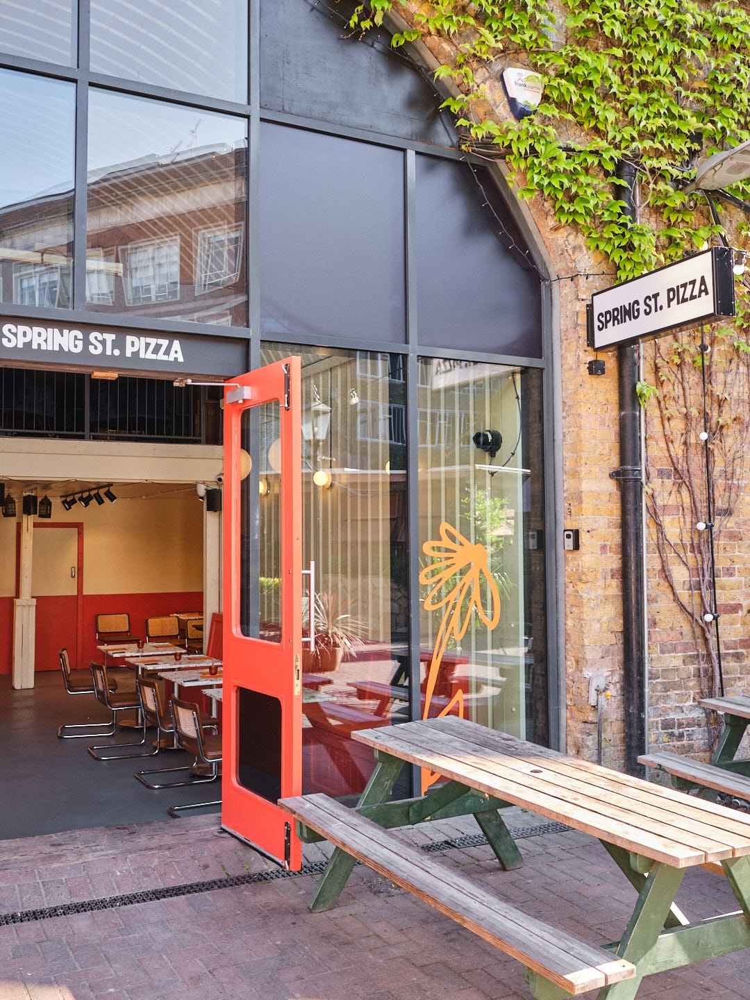 "SpringSt Pizza: modern venue with open entrance for casual meetings and events"