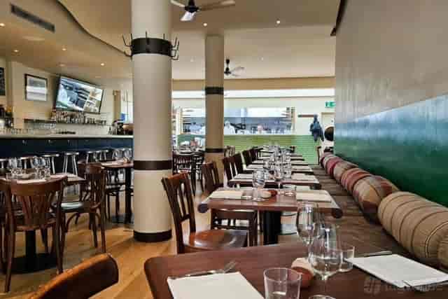 Elegant dining venue in Moro with wooden tables for corporate events and social gatherings.