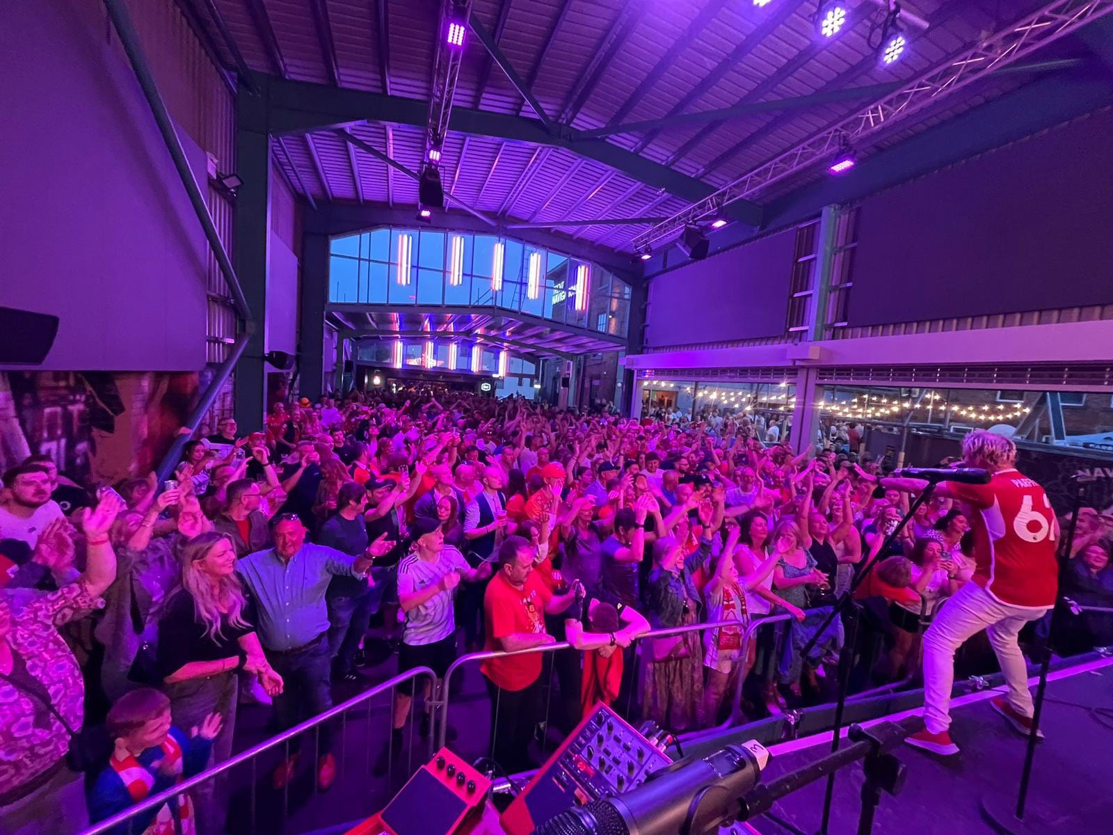 Vibrant crowd at The Big Shed, enjoying lively performance for events and celebrations.
