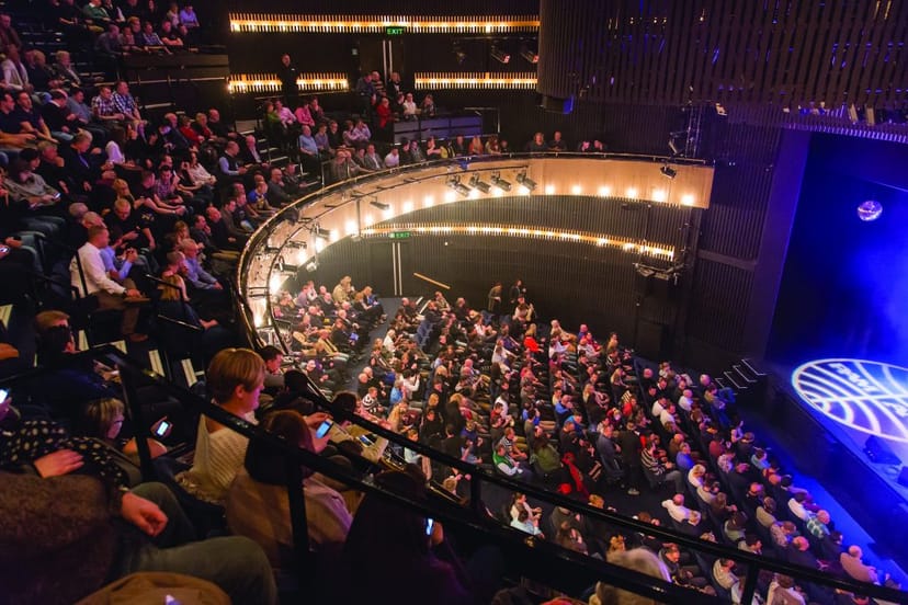 Main Stage Nottingham Playhouse packed audience ready for performance, theater event setting.