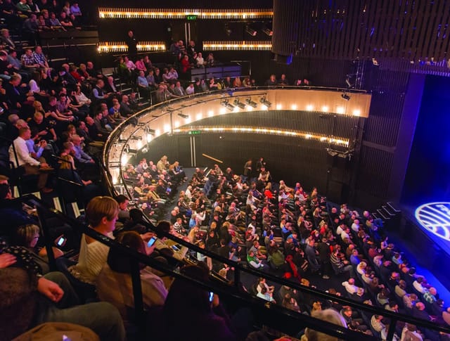 Packed Nottingham Playhouse auditorium showcasing engaged audience at a performance event.