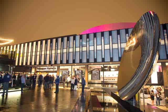 "Nottingham Playhouse event space with vibrant architecture and reflective sculpture."