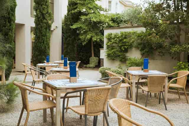 Outdoor event courtyard at Hart's Hotel & Kitchen, featuring tables, greenery, and dining options.
