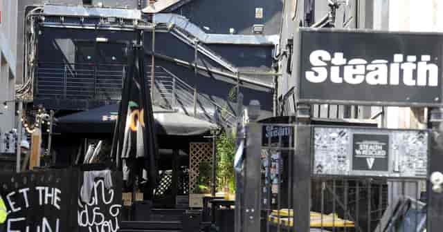 Versatile outdoor venue with black decor, ideal for networking and casual events.