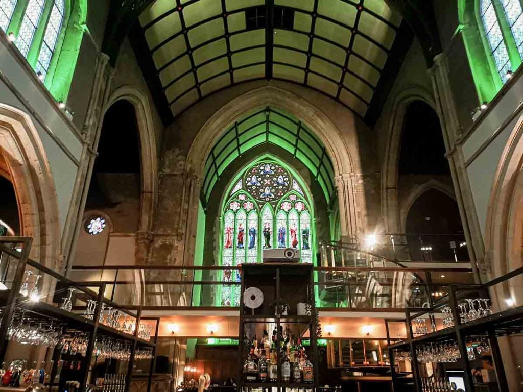 Stunning Mezzanine venue with vaulted ceilings and stained glass, perfect for events. - Banner