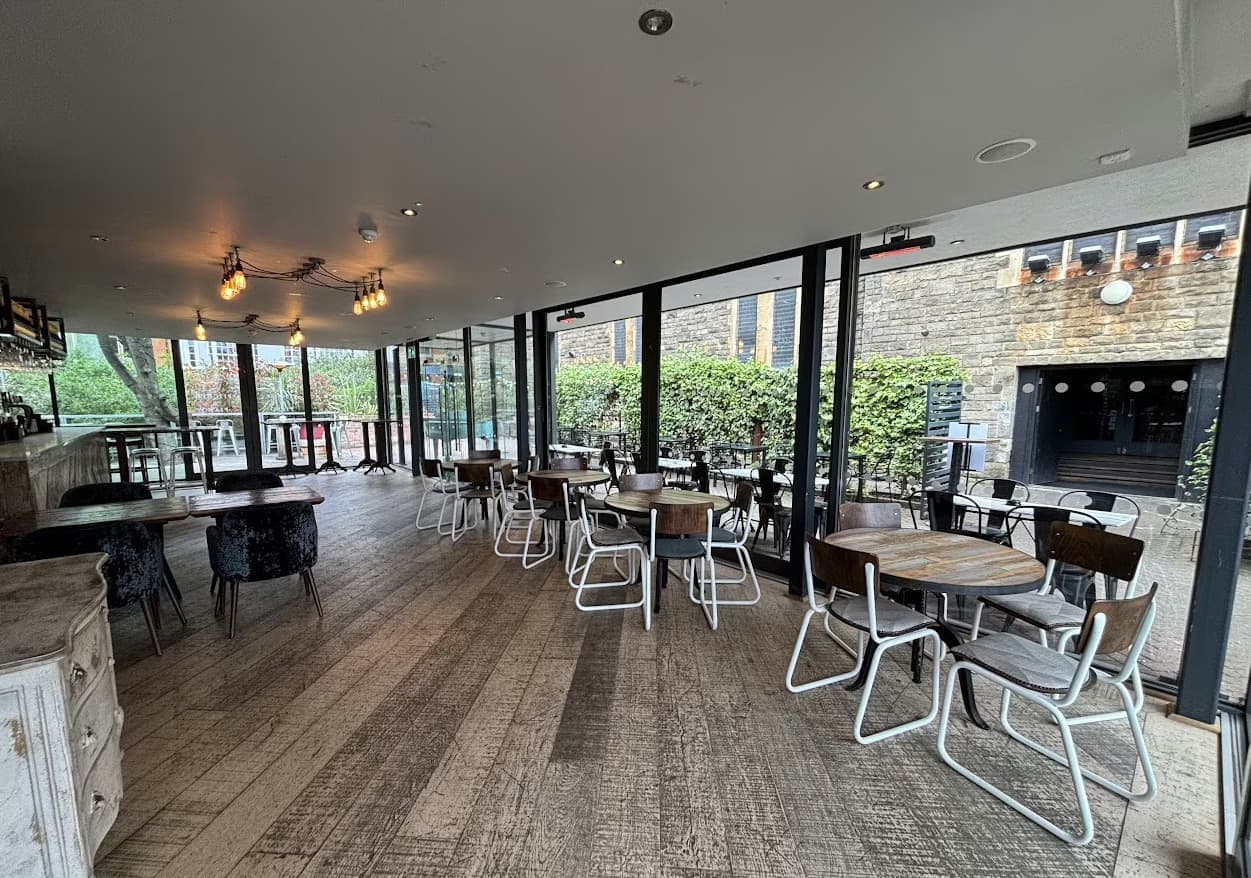 Modern event space with large windows, perfect for corporate meetings or casual gatherings.