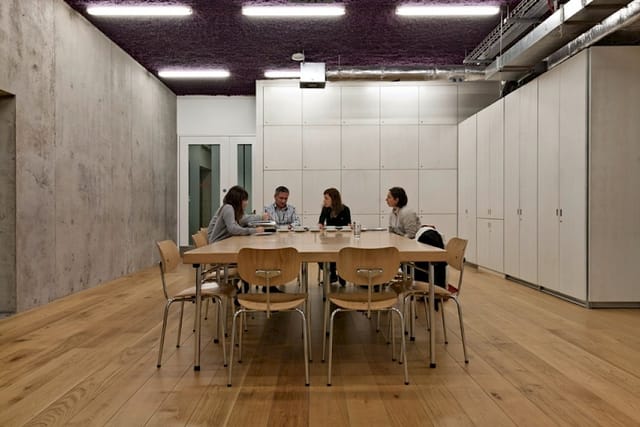 Modern meeting room with wooden table in Nottingham Contemporary, perfect for collaborations.