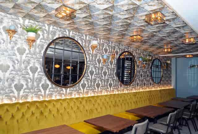 Stylish venue The Snug in West Bridgford with cozy yellow banquette for meetings and events.