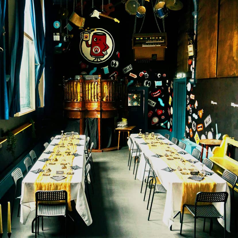 "Downstairs Pub & Microbrewery event space with elegant tables for meetings and dinners"