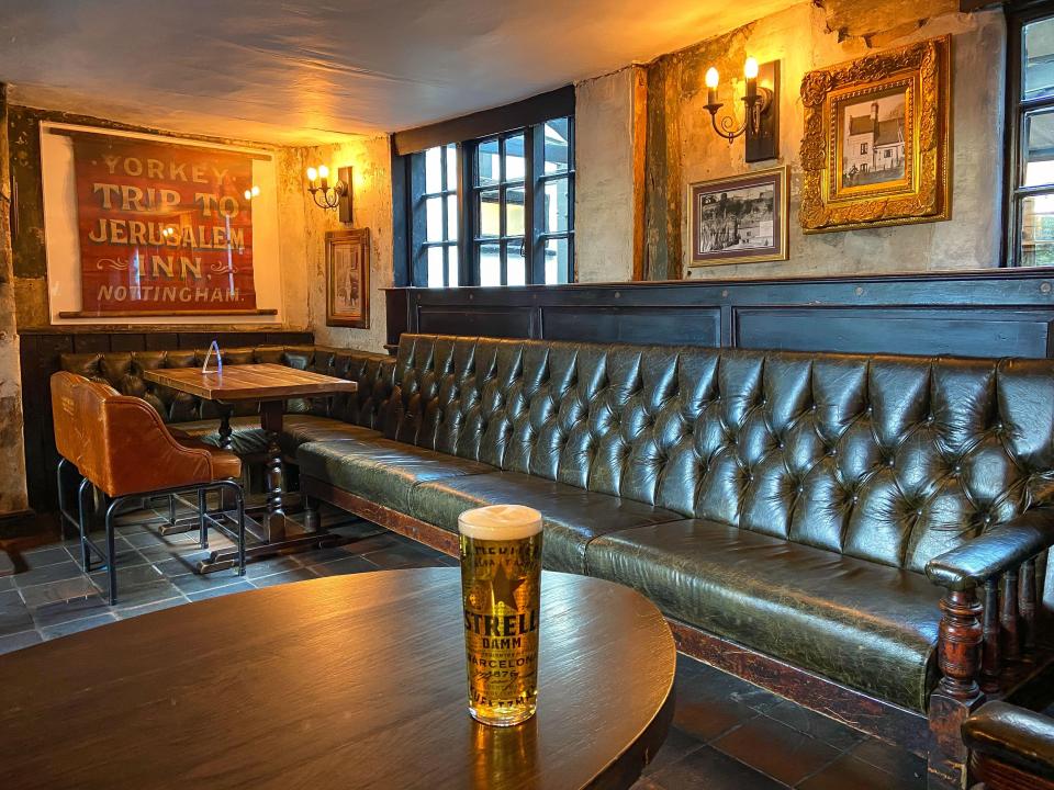 Stylish event space at Bell Inn Cave Cellars with tufted leather seating for gatherings.