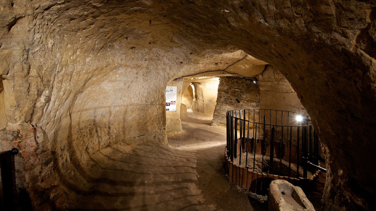 Bell Inn Cave Cellars: unique underground venue with textured stone walls for events.