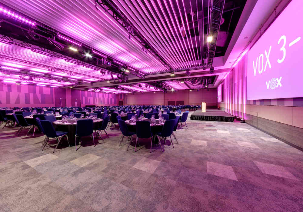 Main Room at Palais Nottingham with pink lighting, ideal for banquets and meetings.