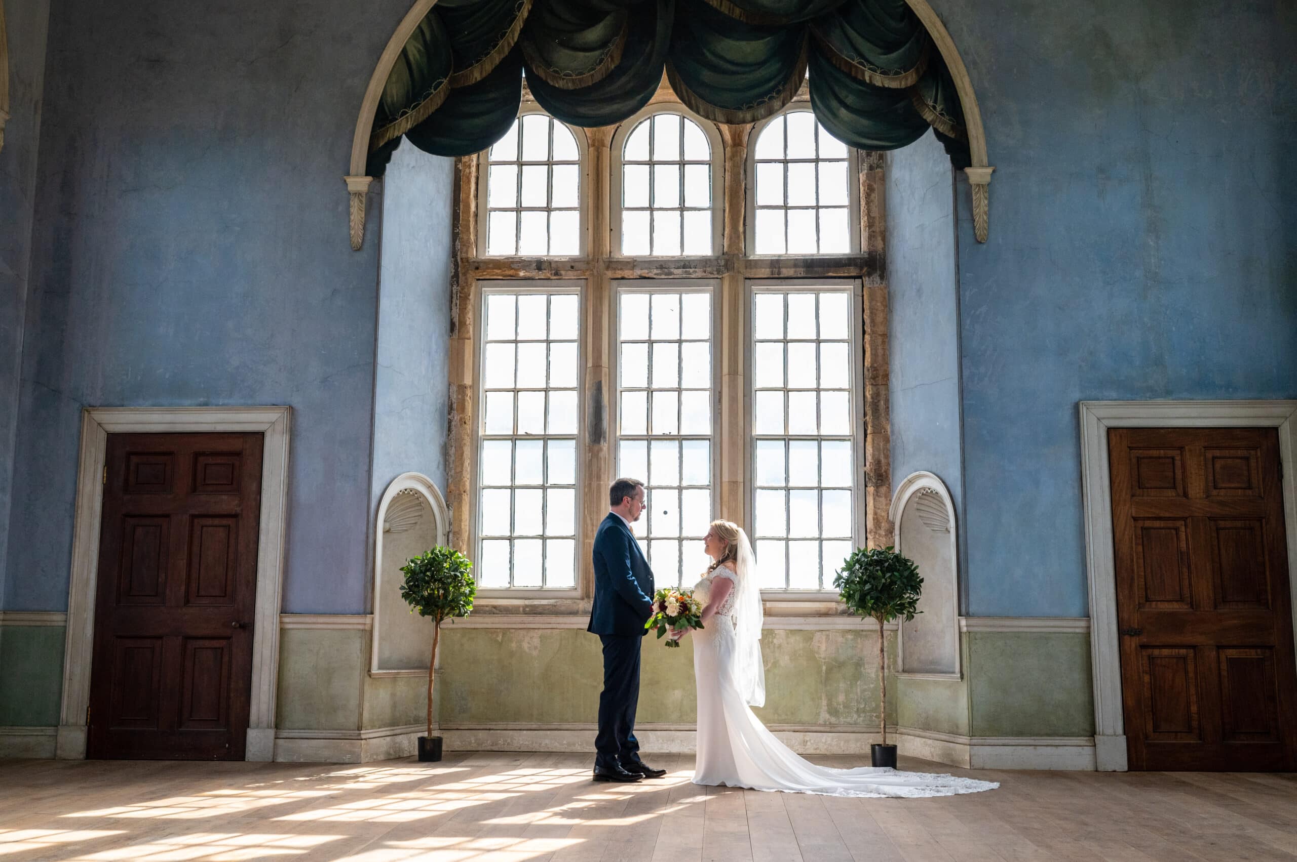 Elegant Lord Middleton Suite with large windows, perfect for romantic wedding ceremonies.