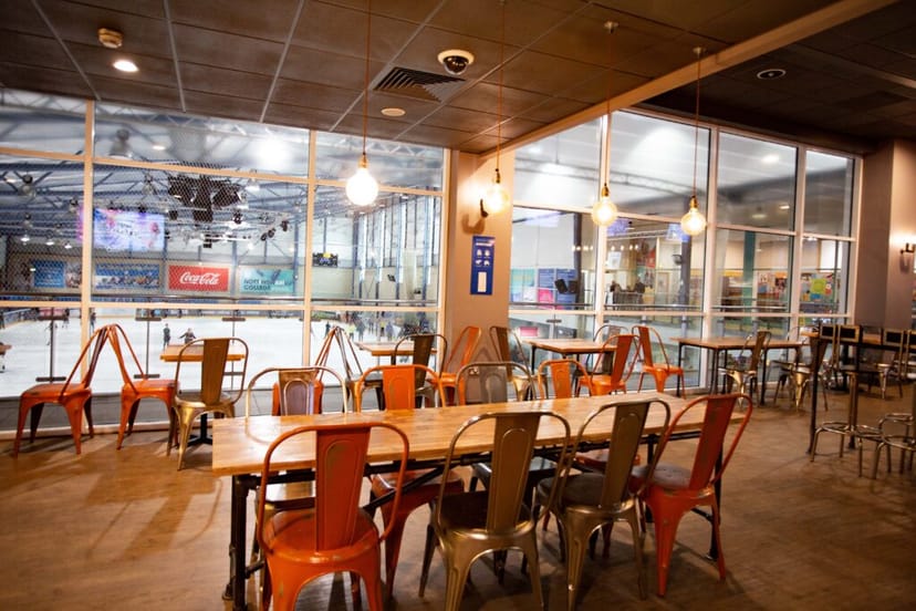 T&D Café at Motorpoint Arena: modern event space with ice rink view for team-building events.