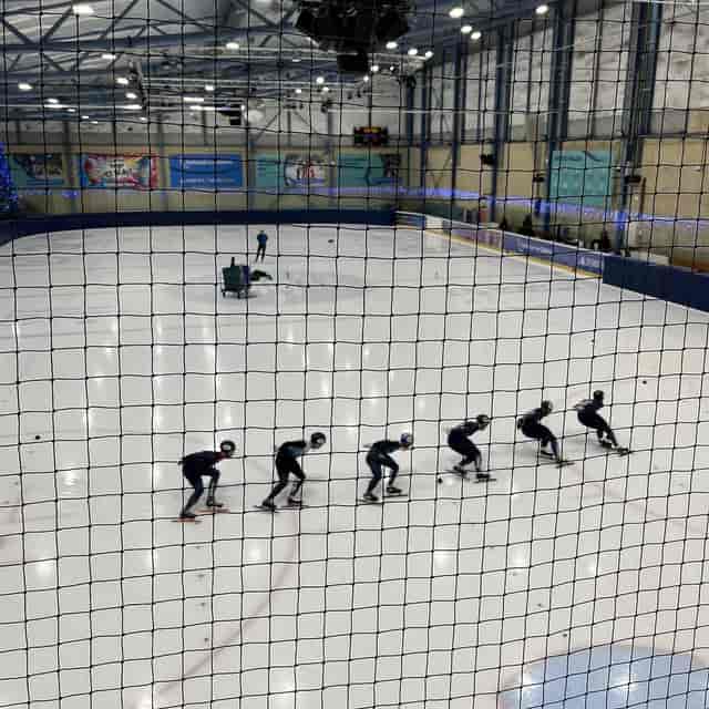 Speed skaters practice at National Ice Centre for corporate winter sports events.