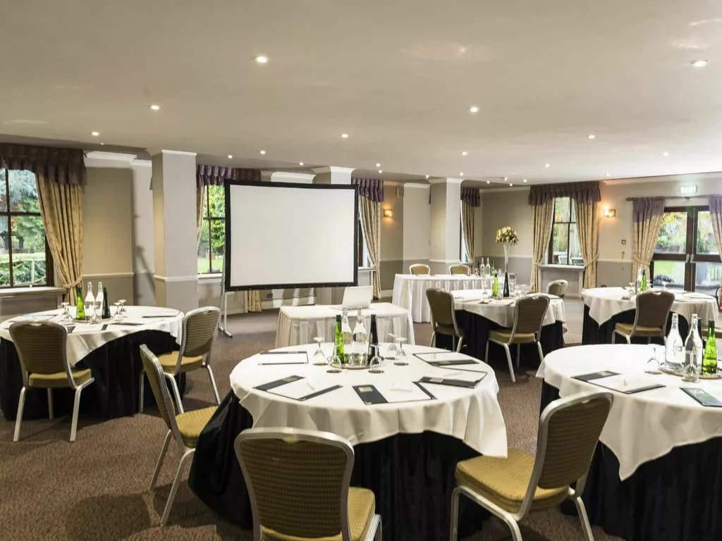 Cabaret style meeting room at Hatherley Manor Hotel, ideal for business conferences and workshops. - Banner