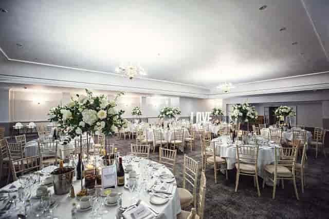 Elegant banquet setup with floral centerpieces in Moat Suite, Hatherley Manor for wedding reception.