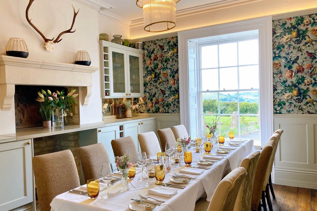Oak Room at Burleigh Court: Long-table setup for private dining and corporate board meetings.