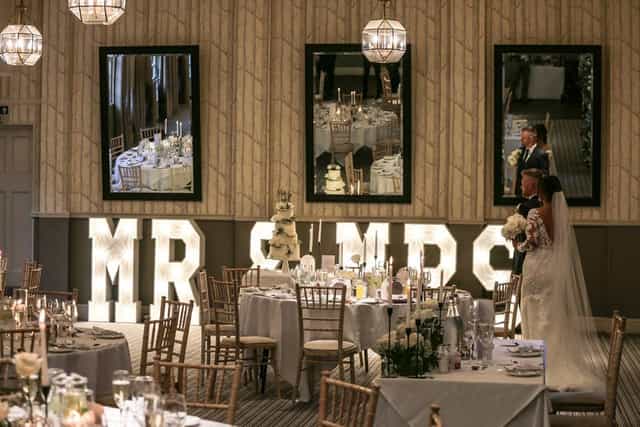Westonbirt Room wedding reception with elegant tables and romantic decor at Hare & Hounds Hotel.