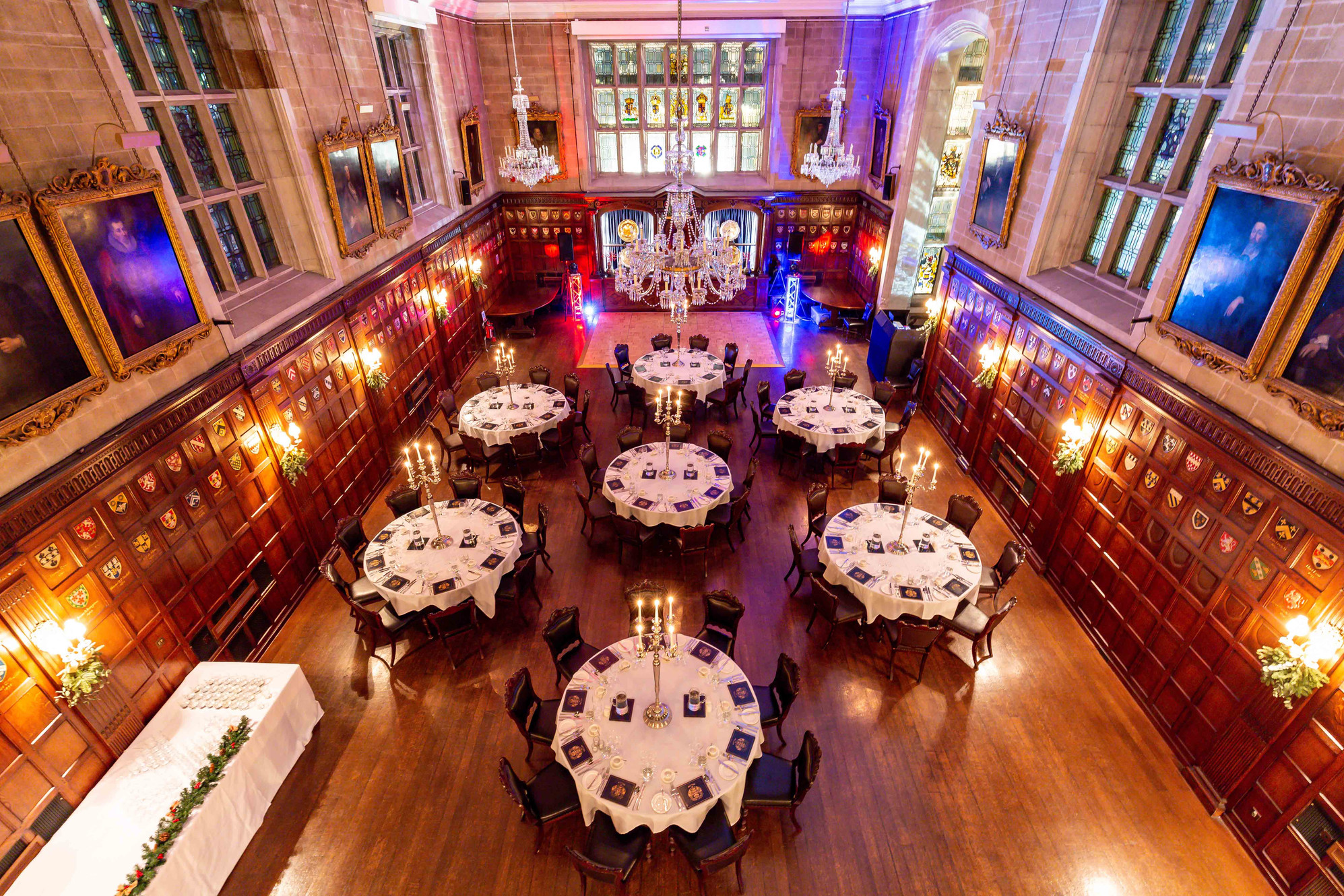 Elegant banquet hall with round tables set for formal events in Ironmongers' Hall. - Banner