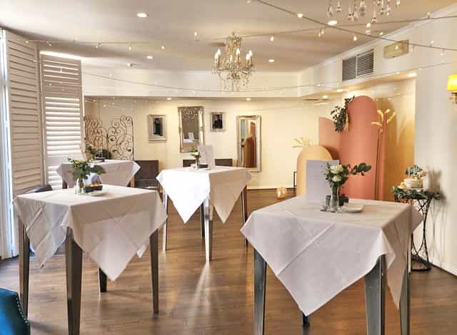 Henley Room cocktail setup with high-top tables for networking events and social mixers.