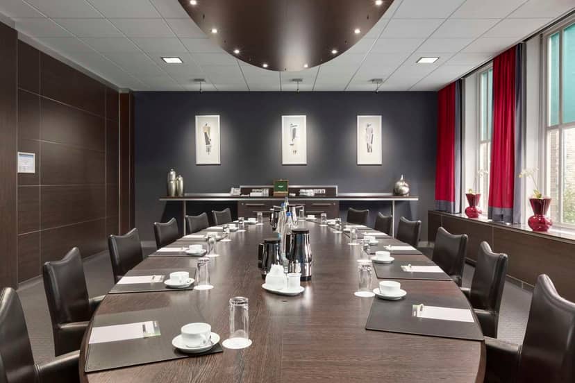 Elegant conference room with polished table at NH Eindhoven Conference Centre, ideal for meetings.