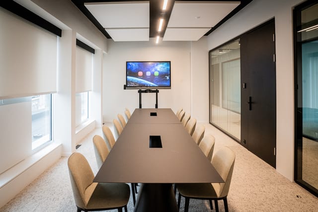 Modern boardroom with AV tech for hybrid meetings and corporate events.