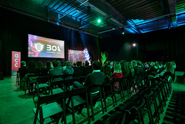 Engaging event setup at Avenue Blackbox with ambient lighting and a large screen.