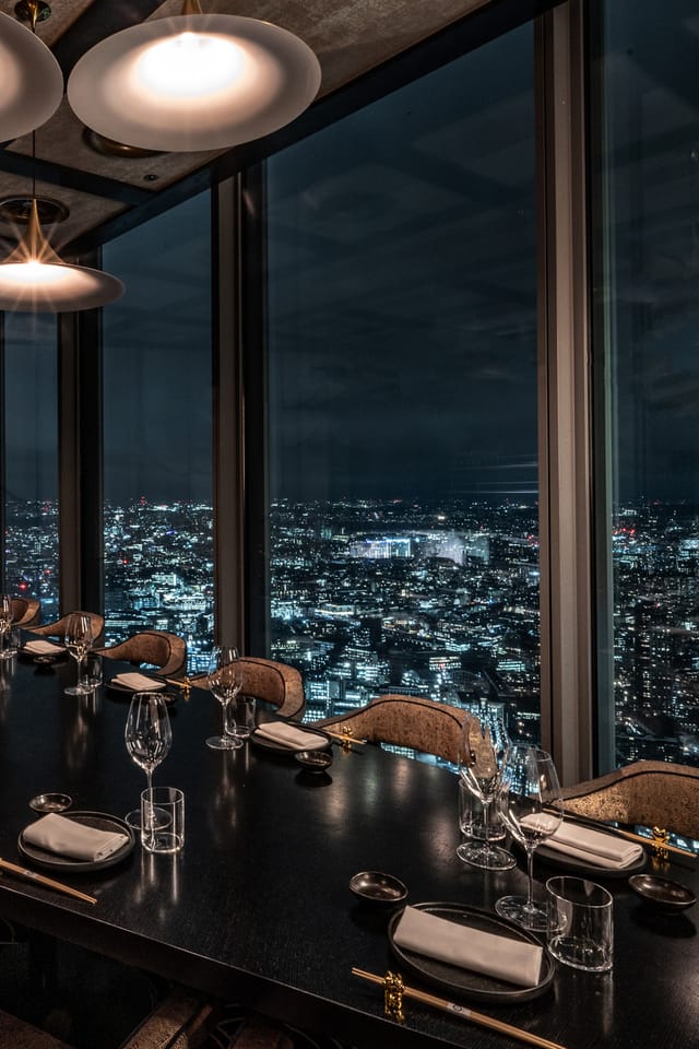 Private dining room at Lucky Cat Bishopsgate with cityscape view, ideal for corporate dinners.
