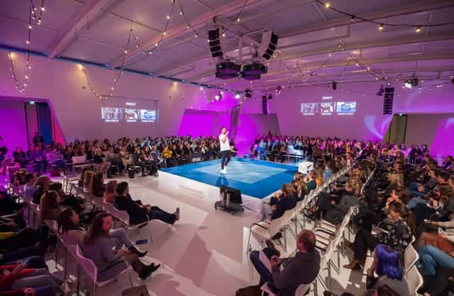 Royal Jaarbeurs plenary stage with 360-degree layout and bistro lighting for corporate events.