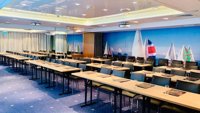 Classroom-style training room at Hotel Gdańsk with mural for professional corporate events.