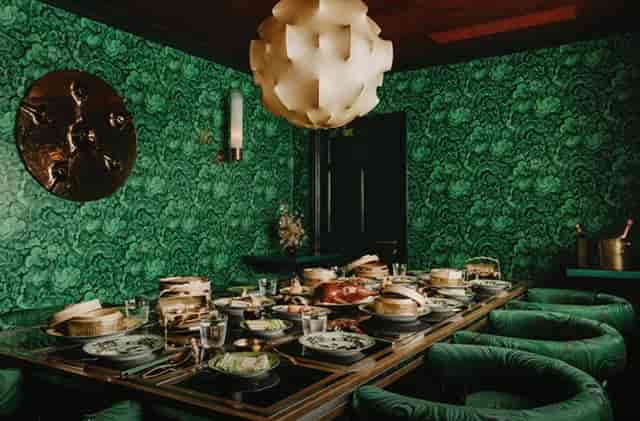 Private dining room at Maison Estelle with bold decor for VIP board meetings and networking events.
