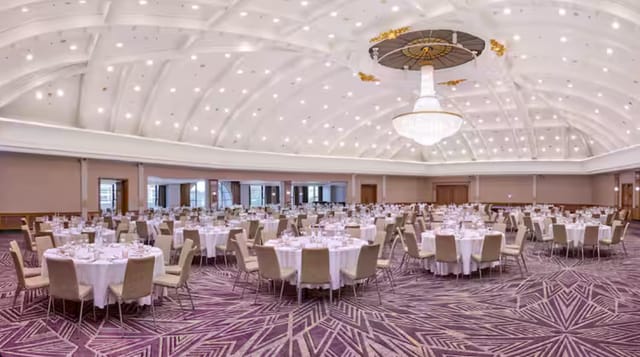 Belle Epoque ballroom with crystal chandelier, ideal for upscale gala and corporate dinner events.