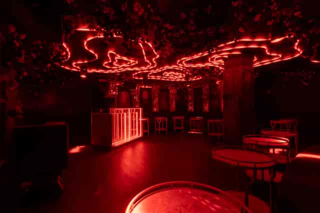 Stylish Helios Room at Selene Nightclub, featuring red lighting for exclusive events.