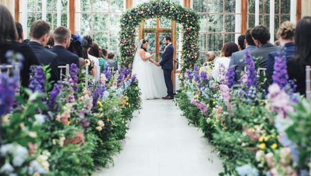 Conservatory wedding, floral arch, romantic event.